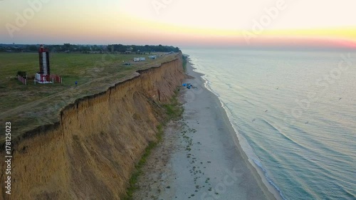 Wallpaper Mural aerial footage of man riding a bicycle on beautiful coast line during sunset or sunrise Torontodigital.ca