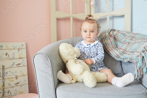 a little girls playing  in the house for dolls with bear. polar bear