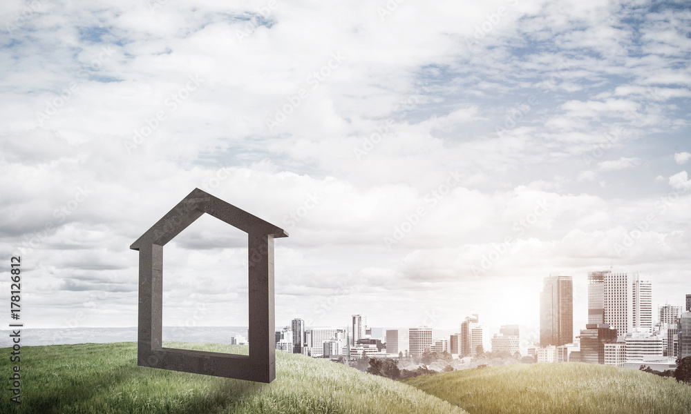 Conceptual image of concrete home sign on hill and natural lands Conceptual image of concrete home sign on hill and natural lands