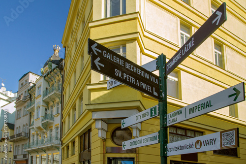 Information street sign in Karlovy Vary on the building background. Czech Republic.