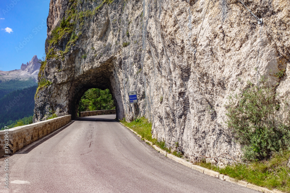 Mountain road and tunnel into the rocks