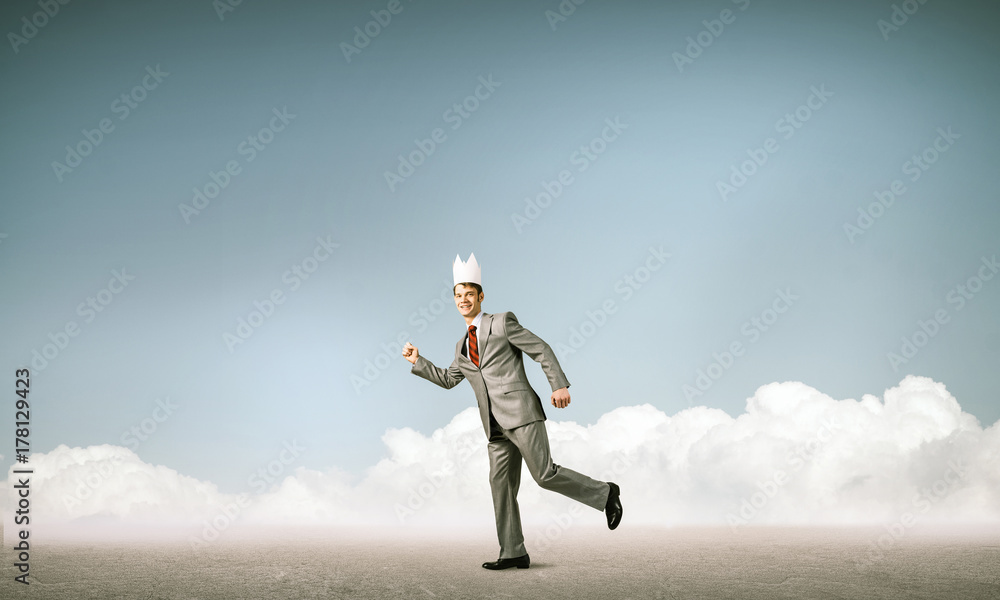 King businessman in elegant suit running and blue cityscape silh