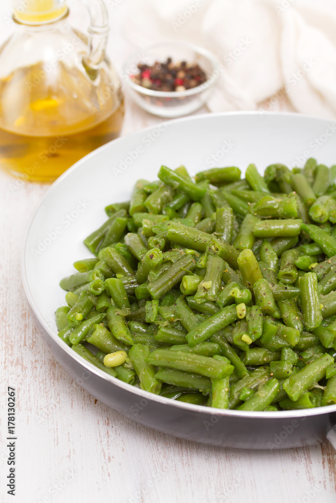 green beans on frying pan on wooden background green beans on frying pan on wooden background