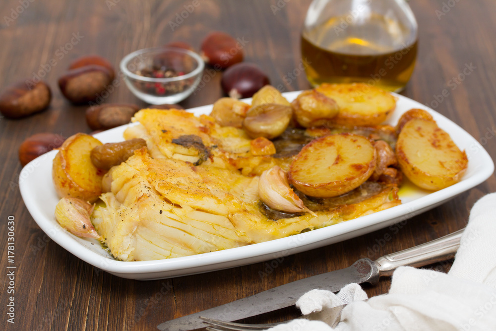 fried cod fish with chestnuts and potato on white dish fried cod fish with chestnuts and potato on white dish