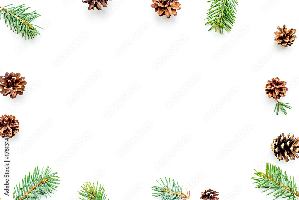 New year symbols pattern. Spruce branches and cones on white background top view copyspace New year symbols pattern. Spruce branches and cones on white background top view copyspace