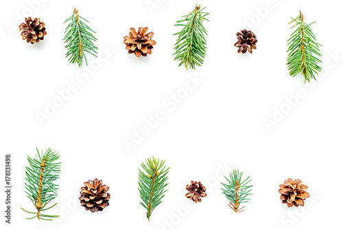 New year symbols pattern. Spruce branches and cones on white background top view copyspace