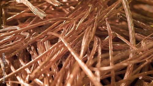 bare wires of copper cables are lying in a heap of scrap metal in factory premise, close-up shot photo