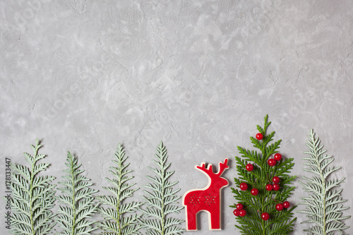 Christmas background with the symbol of the tree and red berries, reindeer