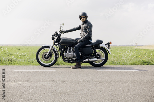 Motorcyclistor rider looking directly at the camera, ready to ride