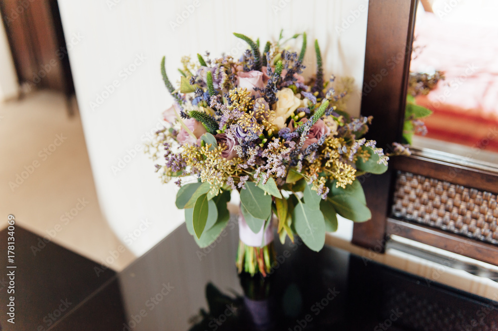 Beautiful wedding bouquet lie on glass table Beautiful wedding bouquet lie on glass table