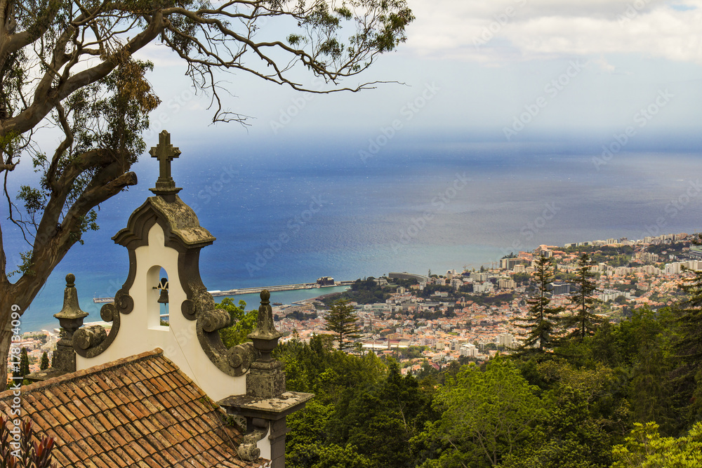view over Funchal in Madeira island from hill botanic garden, catholic symbol