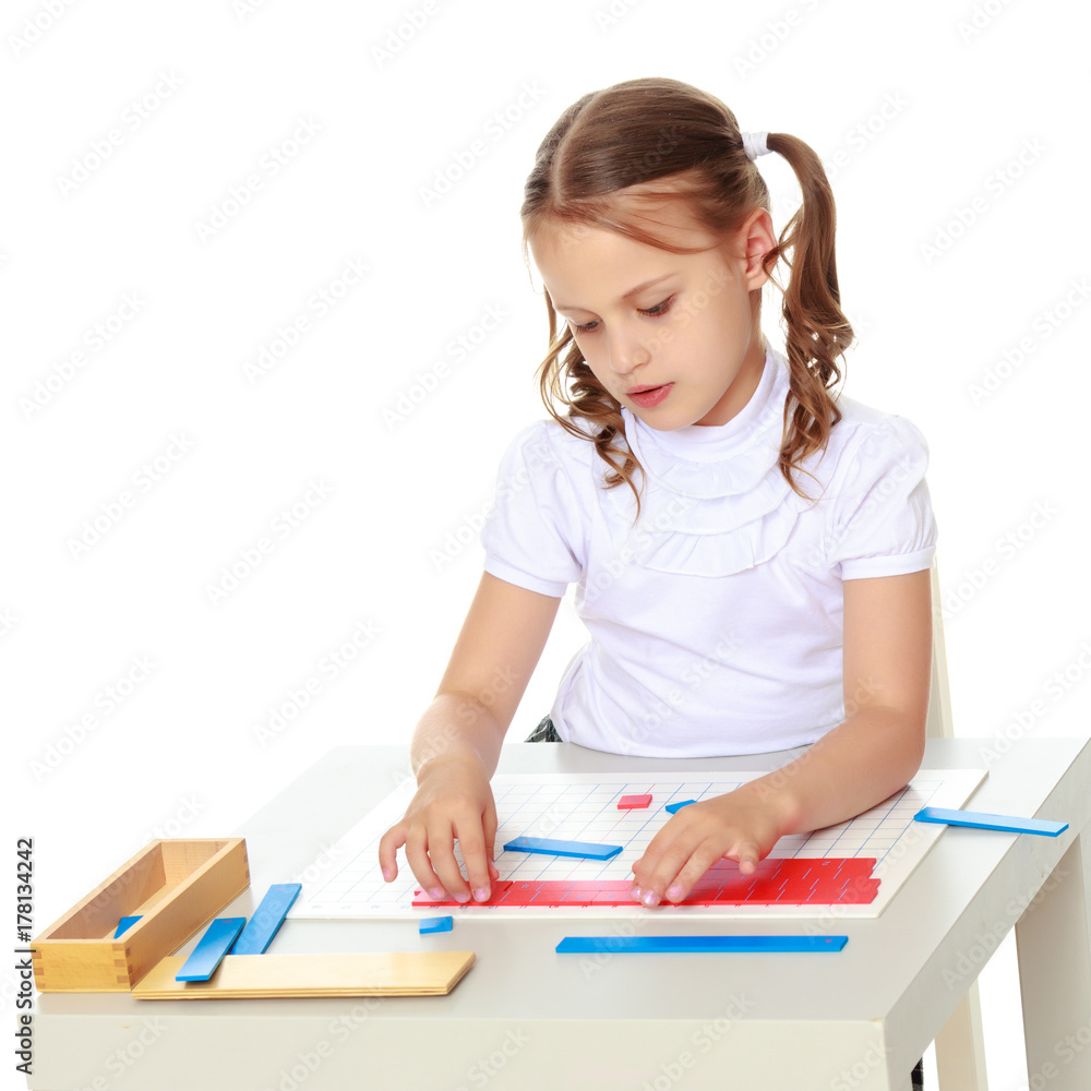A little girl is studying Montessori stuff. A little girl is studying Montessori stuff.