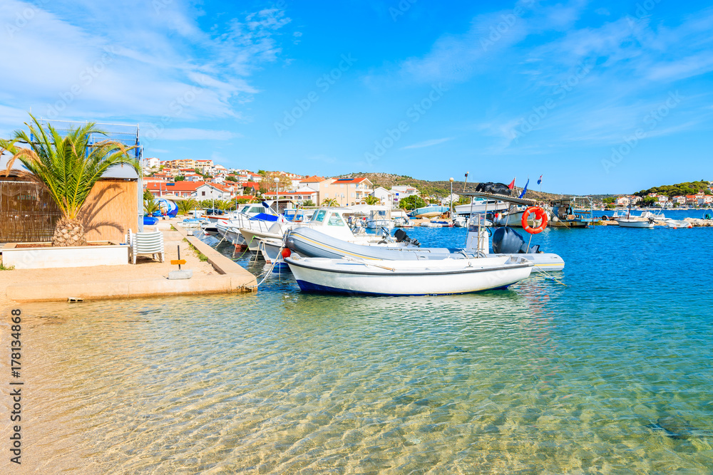 Fishing boats on beach with shallow crystal clear sea water in Rogoznica town, Dalmatia, Croatia