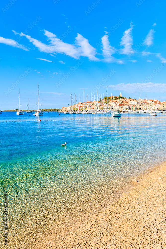 View of beautiful beach with crystal clear turquoise water in Primosten town, Dalmatia, Croatia