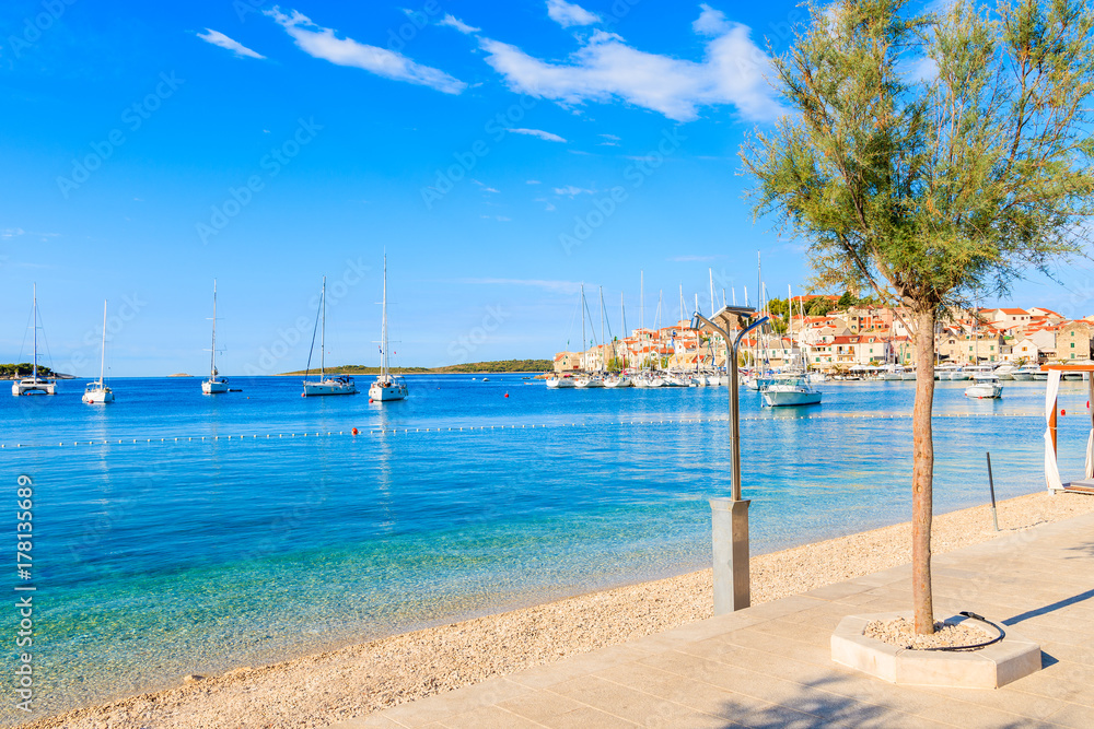 View of beautiful beach and coastal promenade in Primosten town, Dalmatia, Croatia