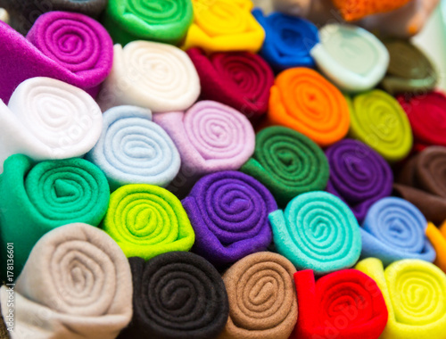 Colorful towels rolled into a tube closeup