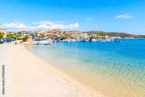 Fototapeta Naklejka Na Ścianę i Meble -  Beach with shallow crystal clear sea water in Rogoznica town, Dalmatia, Croatia