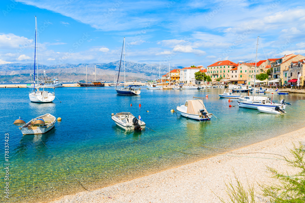 View of beach and boats in Postira village with beautiful port, Brac island, Croatia