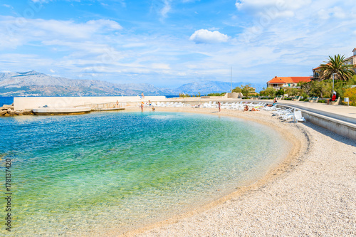 Fototapeta Naklejka Na Ścianę i Meble -  Beach with turquoise sea water in Postira village, Brac island, Croatia