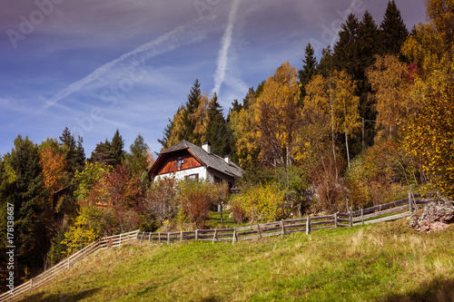 RENON, ITALY - 13 OCTOBER 2017: A maso in the middle of the forest with autumnla colors. Maso is traditional South Tyrol farm photo