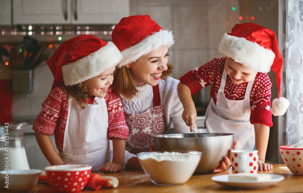happy family mother and children bake cookies for Christmas happy family mother and children bake cookies for Christmas