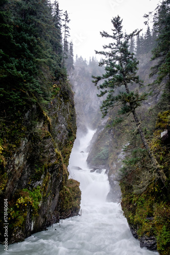 Misty waterfall in Alaska, Valdez. Wild stream.