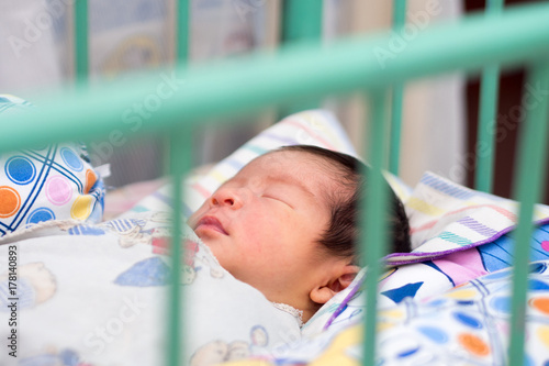 Close Up of Asian Baby Sleeping in Trellis