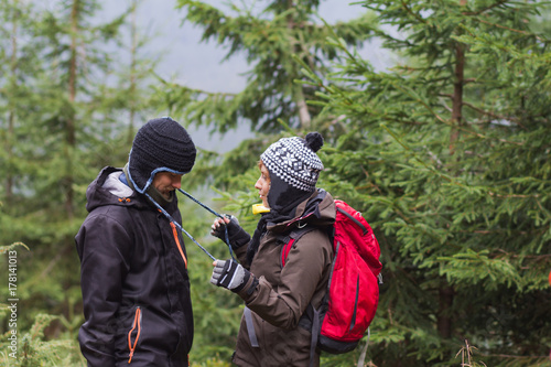 Wallpaper Mural young couple of hikers having good time in autumn mountains  Torontodigital.ca