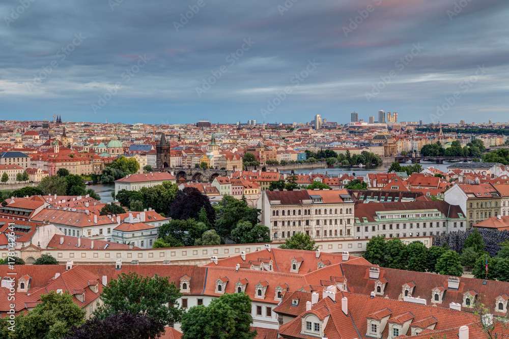 View of buildings at Mala Strana (Lesser Town), Old Town and beyond in Prague, Czech Republic, viewed slightly from above in the early evening.
