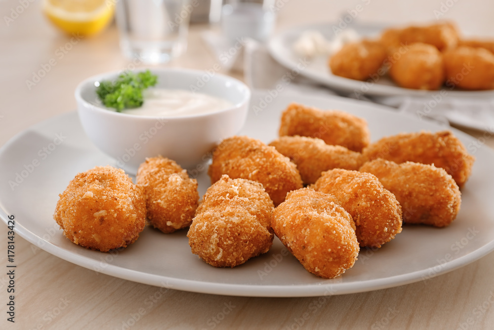 Plate with delicious salmon croquettes on table, closeup Plate with delicious salmon croquettes on table, closeup