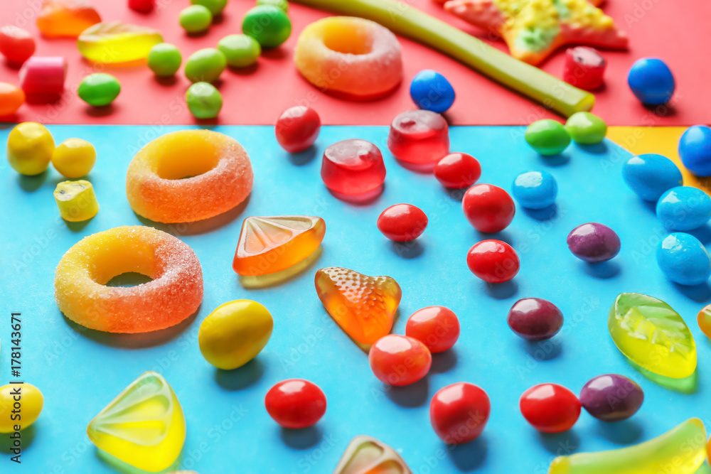 Delicious candies on color background Delicious candies on color background