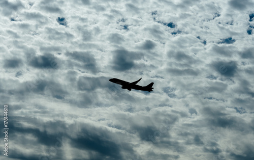 Fototapeta Naklejka Na Ścianę i Meble -  Jet Airplane Silhouette With White Cloud Background