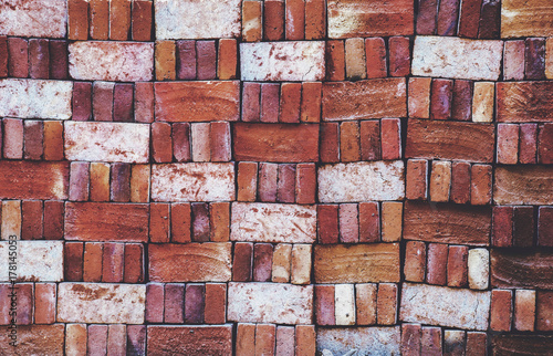 Pile of locally produced and neatly arranged red bricks creates a pattern photo