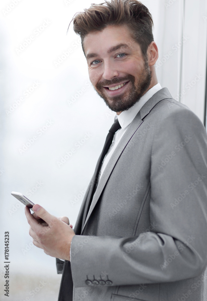 Stylish man in suit is reading information on phone Stylish man in suit is reading information on phone