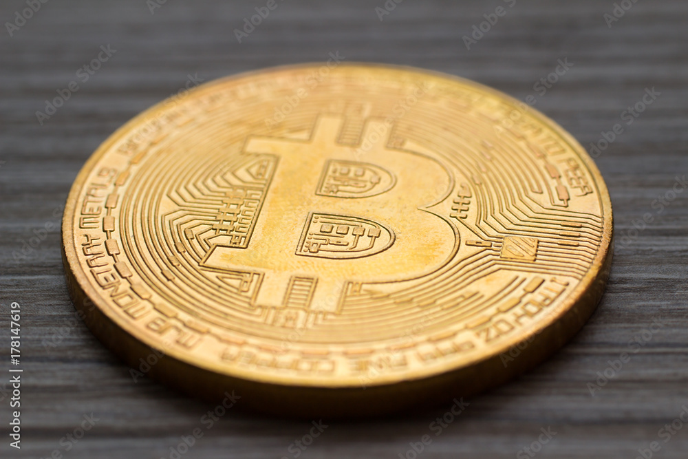 Close-up of a bitcoin on desk Close-up of a bitcoin on desk