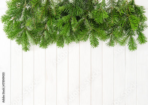 Christmas tree branches bright wooden background © LiliGraphie