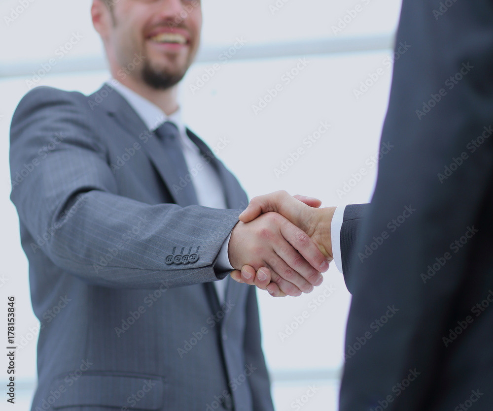 Close up photo of the happy successful businessmen shaking hands