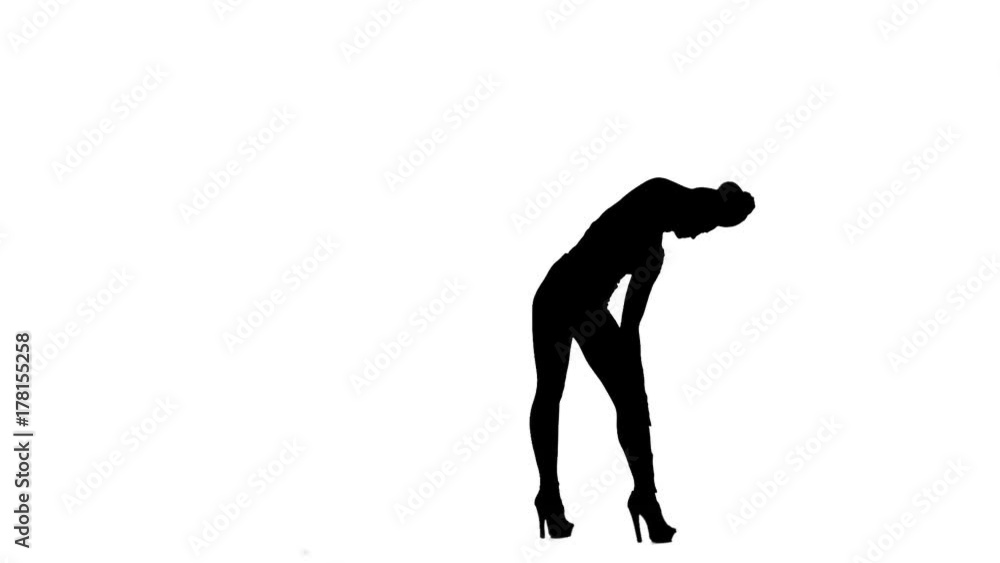 Fashion model is sexually wriggling her body. Silhouette. White background. Slow motion Fashion model is sexually wriggling her body. Silhouette. White background. Slow motion