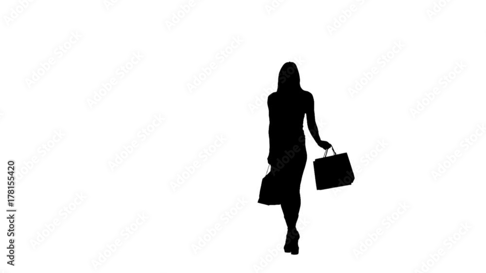 Woman with packages in hands posing for a camera, she is on high heels. Silhouette. White background. Slow motion Woman with packages in hands posing for a camera, she is on high heels. Silhouette. White background. Slow motion