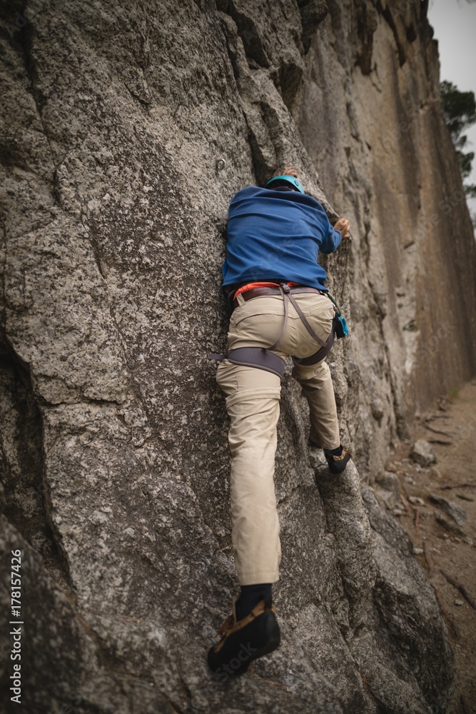 Man climbing a cliff Man climbing a cliff