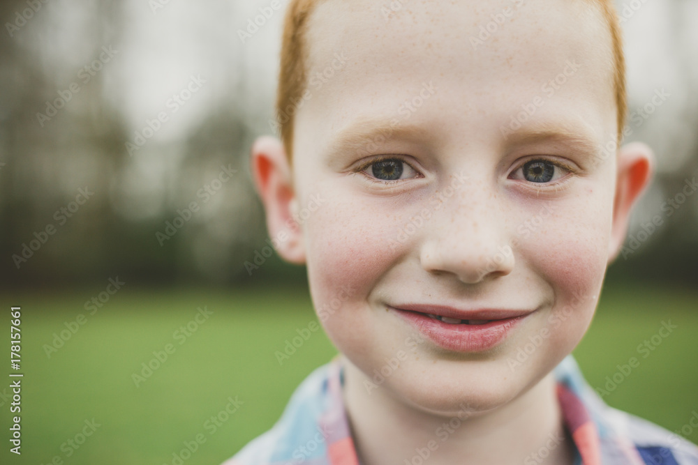 Portrait of a cute young boy smiling in a field Portrait of a cute young boy smiling in a field