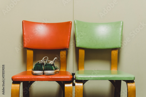 two retro chairs with a pair of green plaid sneakers photo