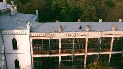 Aerial view on abandoned ruined castle and park. Autumn color footage in sunset light. photo