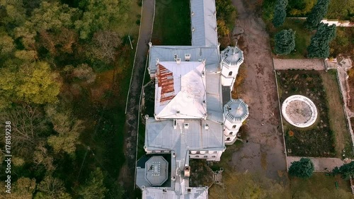 Aerial view on abandoned ruined castle and park. Autumn color footage in sunset light. photo