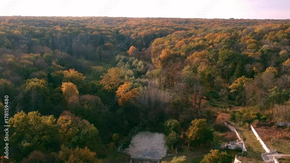 Aerial view on abandoned ruined castle and park. Autumn color footage in sunset light. Aerial view on abandoned ruined castle and park. Autumn color footage in sunset light.