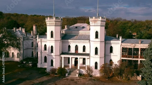 Aerial view on abandoned ruined castle and park. Autumn color footage in sunset light. photo