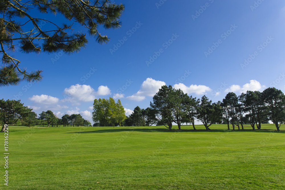 General view of a green golf course on a bright sunny day. Idyllic summer landscape. Sport, relax, recreation and leisure concept General view of a green golf course on a bright sunny day. Idyllic summer landscape. Sport, relax, recreation and leisure concept