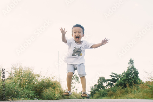 Healthy And Cheerful Asian Kids Is Jumping Happily , Outdoor