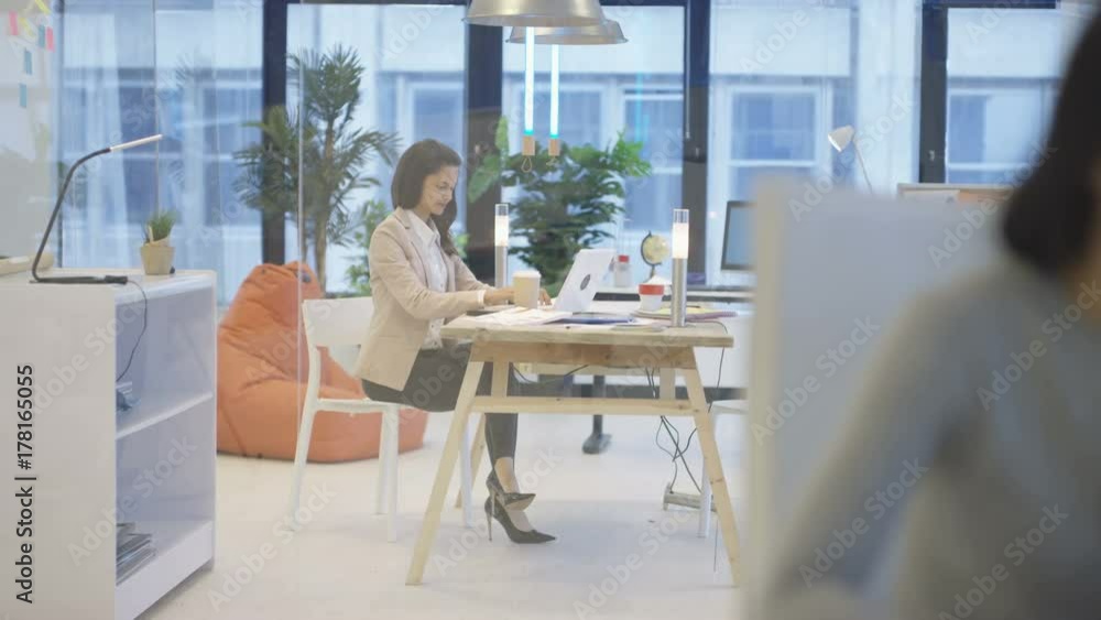 Attractive businesswoman in creative office brainstorming with sticky notes Attractive businesswoman in creative office brainstorming with sticky notes