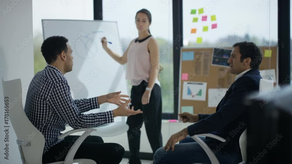 Business man & woman in modern office, looking at tablet & discussing ideas Business man & woman in modern office, looking at tablet & discussing ideas